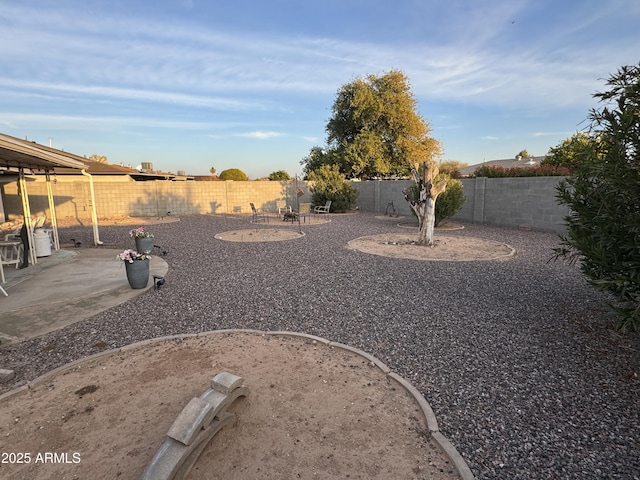 view of yard featuring a patio and a fenced backyard