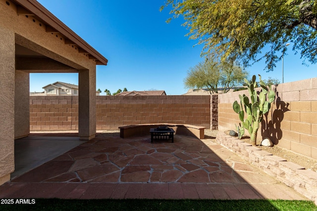 view of patio / terrace with a fire pit and a fenced backyard