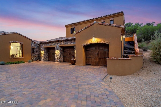9514 E Madera Dr, Scottsdale, AZ 85262 - mediterranean / spanish home featuring a tiled roof, an attached garage, decorative driveway, and stucco siding