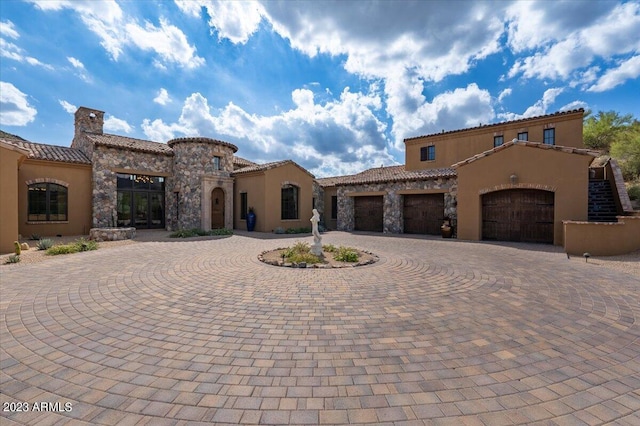 9514 E Madera Dr, Scottsdale, AZ 85262 - mediterranean / spanish home with a chimney, curved driveway, an attached garage, and stucco siding