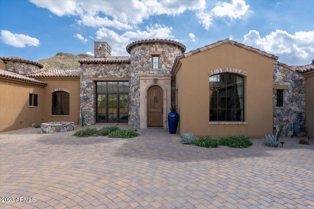 9514 E Madera Dr, Scottsdale, AZ 85262 - view of front of house featuring stucco siding, a chimney, french doors, stone siding, and a tile roof