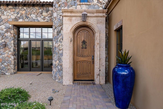 9514 E Madera Dr, Scottsdale, AZ 85262 - view of exterior entry featuring stucco siding, stone siding, and french doors
