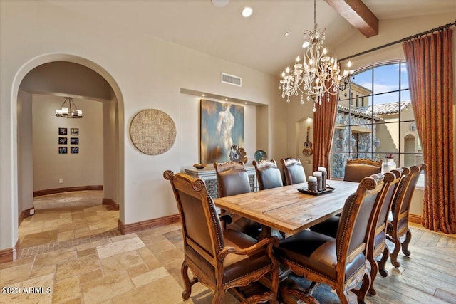 9514 E Madera Dr, Scottsdale, AZ 85262 - dining room with visible vents, baseboards, arched walkways, stone tile flooring, and a chandelier