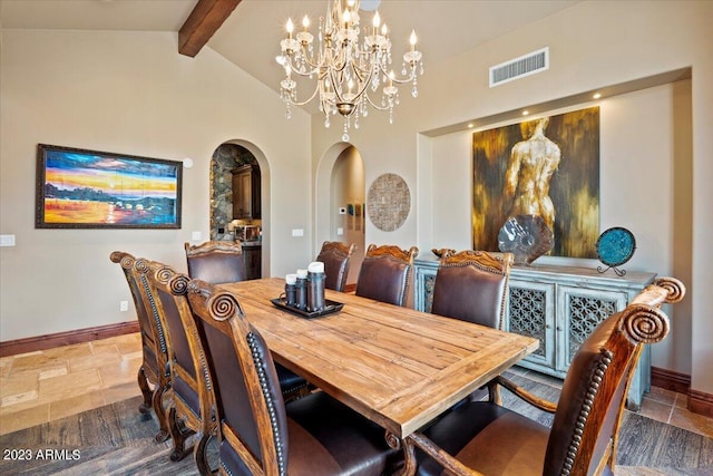 9514 E Madera Dr, Scottsdale, AZ 85262 - dining space with arched walkways, visible vents, a chandelier, vaulted ceiling with beams, and stone tile flooring