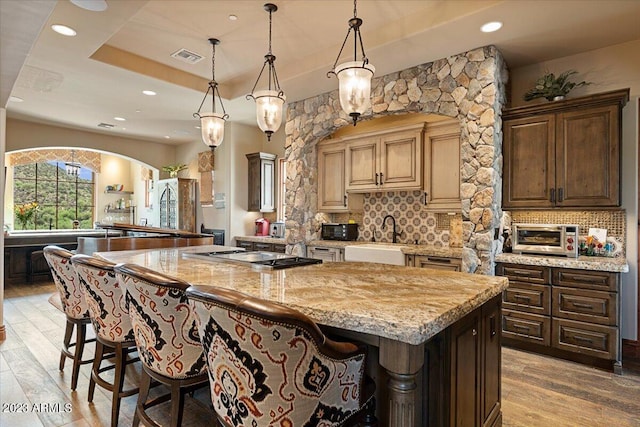 9514 E Madera Dr, Scottsdale, AZ 85262 - kitchen featuring a sink, backsplash, a center island, and stainless steel gas cooktop