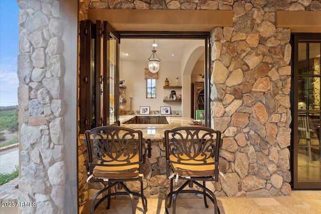 9514 E Madera Dr, Scottsdale, AZ 85262 - wine cellar featuring bar area, arched walkways, and stone finish floor