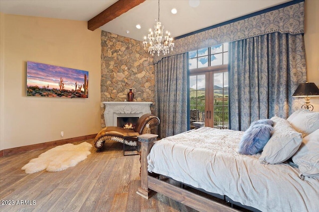 9514 E Madera Dr, Scottsdale, AZ 85262 - bedroom with a lit fireplace, baseboards, lofted ceiling with beams, a chandelier, and wood finished floors