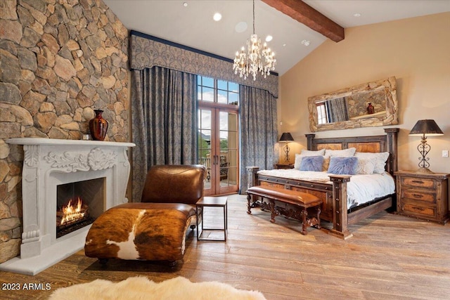 9514 E Madera Dr, Scottsdale, AZ 85262 - bedroom featuring a notable chandelier, access to outside, a lit fireplace, beamed ceiling, and wood finished floors