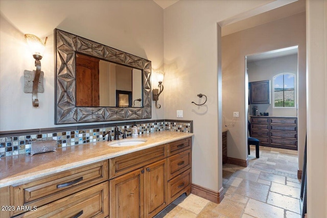 9514 E Madera Dr, Scottsdale, AZ 85262 - bathroom featuring tasteful backsplash, stone tile flooring, baseboards, and vanity