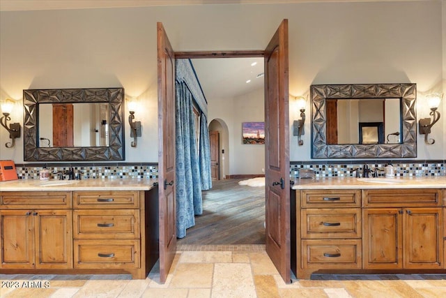 9514 E Madera Dr, Scottsdale, AZ 85262 - bathroom with tasteful backsplash, stone tile floors, two vanities, and a sink