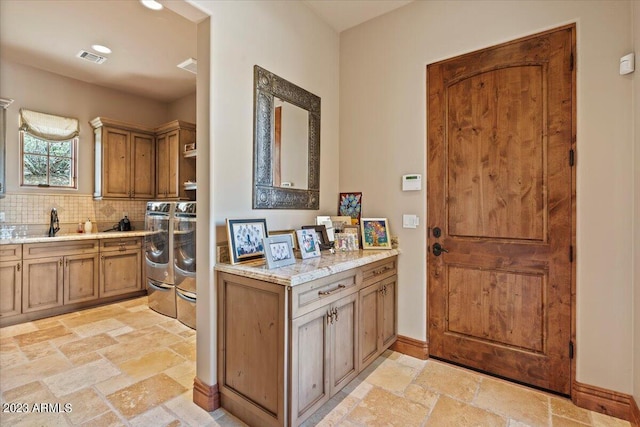 9514 E Madera Dr, Scottsdale, AZ 85262 - kitchen with tasteful backsplash, visible vents, a sink, stone tile floors, and washing machine and clothes dryer