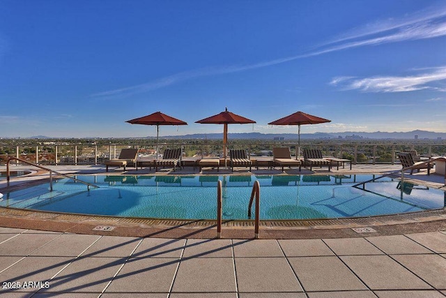 pool featuring a mountain view and a patio