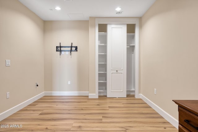 unfurnished bedroom featuring recessed lighting, light wood-style flooring, and baseboards