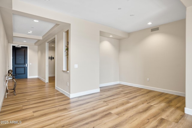 spare room featuring visible vents, baseboards, recessed lighting, and light wood-style floors