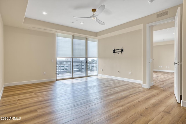 spare room featuring ceiling fan, baseboards, and visible vents