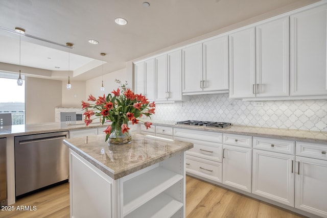 kitchen featuring white cabinets, decorative backsplash, and appliances with stainless steel finishes