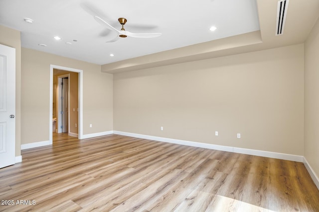 unfurnished room with light wood-style floors, ceiling fan, baseboards, and visible vents
