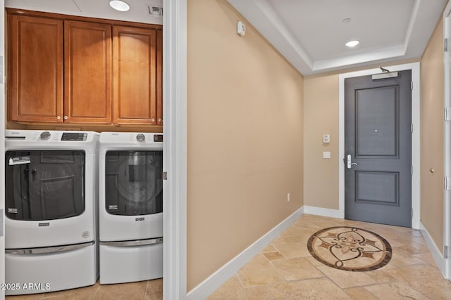 washroom featuring independent washer and dryer, stone tile floors, visible vents, and baseboards