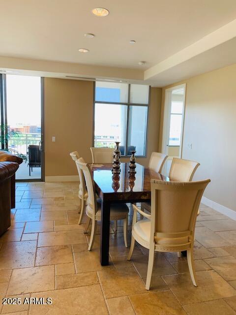 dining room featuring recessed lighting, stone tile floors, and baseboards