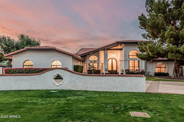5602 W Alameda Rd, Glendale, AZ 85310 - mediterranean / spanish-style home with stucco siding, a tiled roof, and a front yard