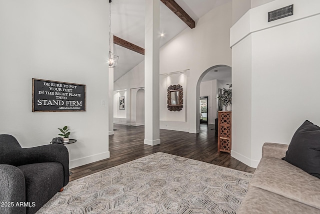 5602 W Alameda Rd, Glendale, AZ 85310 - living room with arched walkways, beamed ceiling, high vaulted ceiling, baseboards, and wood finished floors