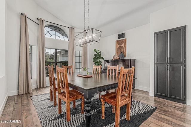 5602 W Alameda Rd, Glendale, AZ 85310 - dining room with a chandelier, wood finished floors, baseboards, and vaulted ceiling