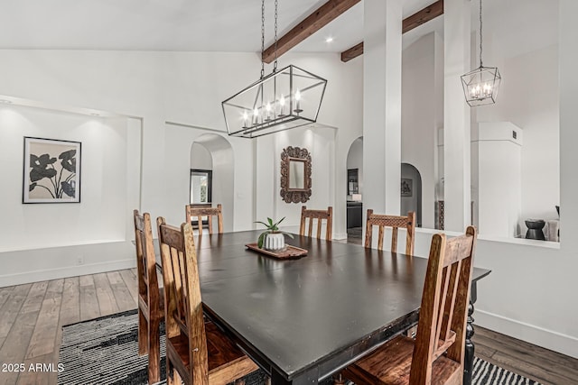 5602 W Alameda Rd, Glendale, AZ 85310 - dining area featuring arched walkways, a chandelier, high vaulted ceiling, wood finished floors, and beam ceiling