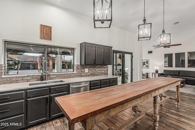 5602 W Alameda Rd, Glendale, AZ 85310 - kitchen featuring a sink, stainless steel dishwasher, a chandelier, tasteful backsplash, and dark cabinets