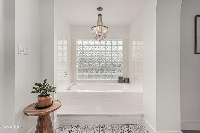 5602 W Alameda Rd, Glendale, AZ 85310 - bathroom with a chandelier, a garden tub, and baseboards