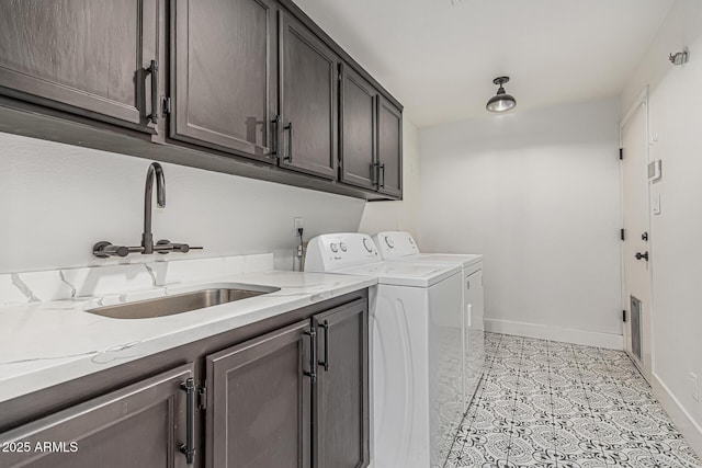 5602 W Alameda Rd, Glendale, AZ 85310 - laundry room with cabinet space, washer and clothes dryer, baseboards, and light tile patterned floors