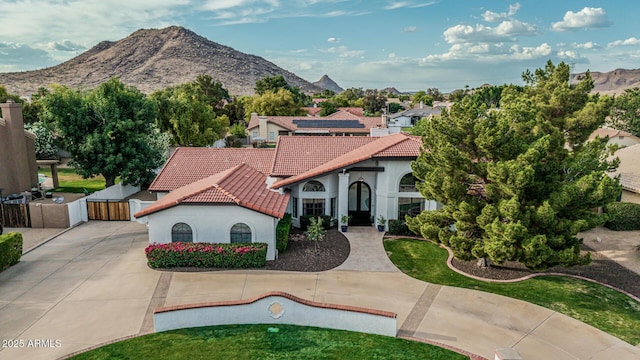 5602 W Alameda Rd, Glendale, AZ 85310 - mediterranean / spanish-style home featuring a gate, a tile roof, stucco siding, and a mountain view