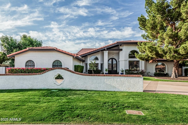 5602 W Alameda Rd, Glendale, AZ 85310 - mediterranean / spanish-style home featuring stucco siding, a front yard, and a tile roof