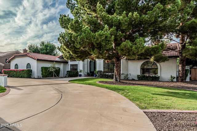 5602 W Alameda Rd, Glendale, AZ 85310 - mediterranean / spanish-style home featuring stucco siding, curved driveway, a tiled roof, and a chimney