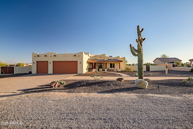 southwest-style home with a garage