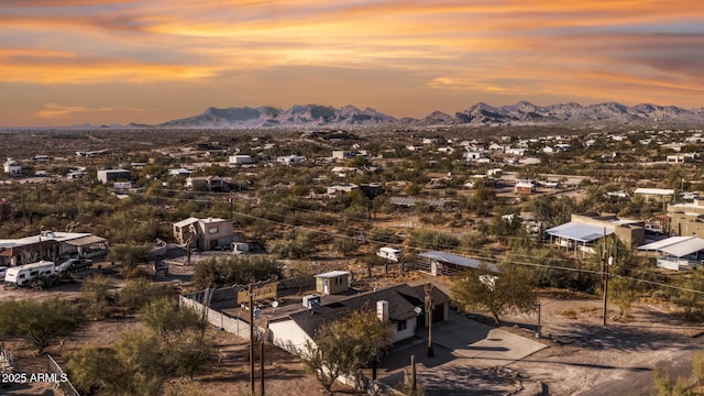 aerial view at dusk featuring a mountain view