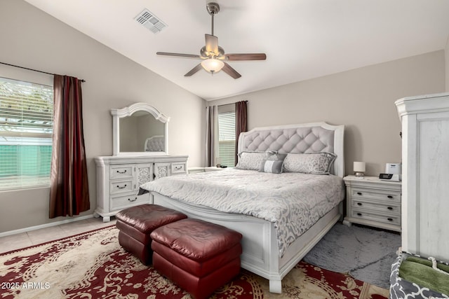 bedroom with light tile patterned floors, ceiling fan, visible vents, and vaulted ceiling