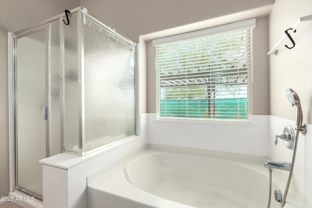 bathroom with a garden tub and a shower stall