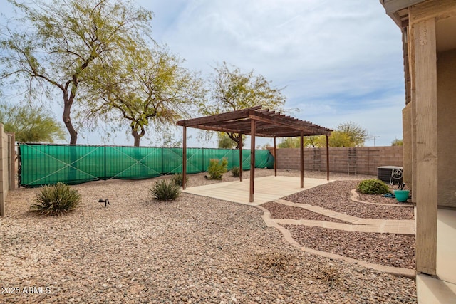 view of yard with a patio area, a fenced backyard, central AC unit, and a pergola