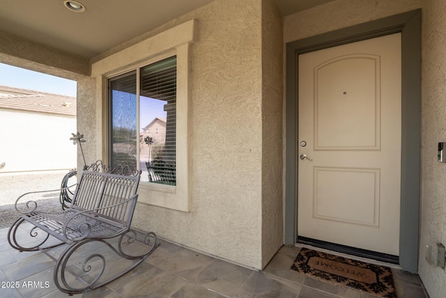 view of exterior entry featuring stucco siding