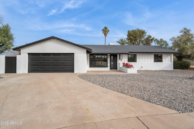 single story home with an attached garage, concrete driveway, and roof with shingles