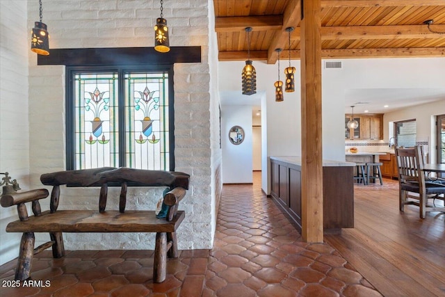 dining room featuring beamed ceiling and wooden ceiling