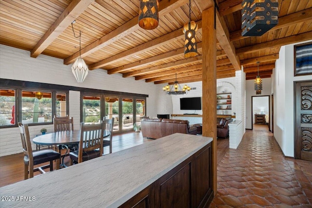 kitchen with french doors, wood ceiling, an inviting chandelier, beamed ceiling, and hanging light fixtures