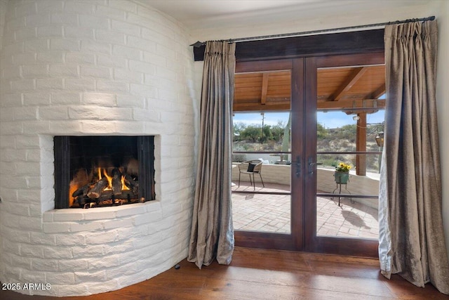 entryway with a fireplace, french doors, and hardwood / wood-style flooring