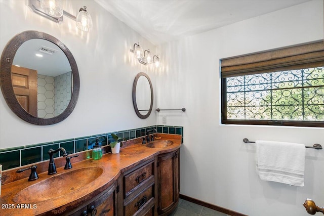 bathroom with tile patterned flooring, vanity, and backsplash