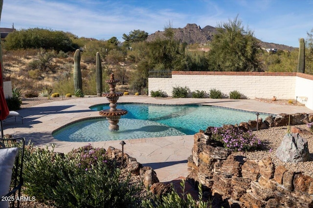 view of swimming pool featuring a patio area and a mountain view