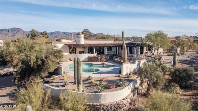 rear view of house featuring a mountain view and a patio