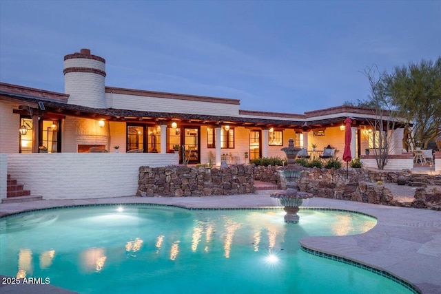 view of pool at dusk