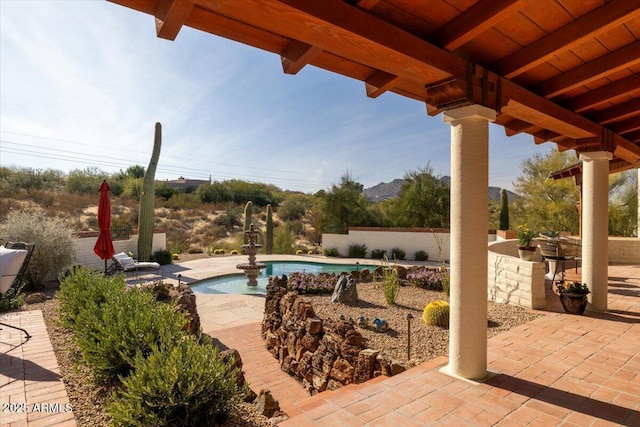 view of patio / terrace with a fenced in pool