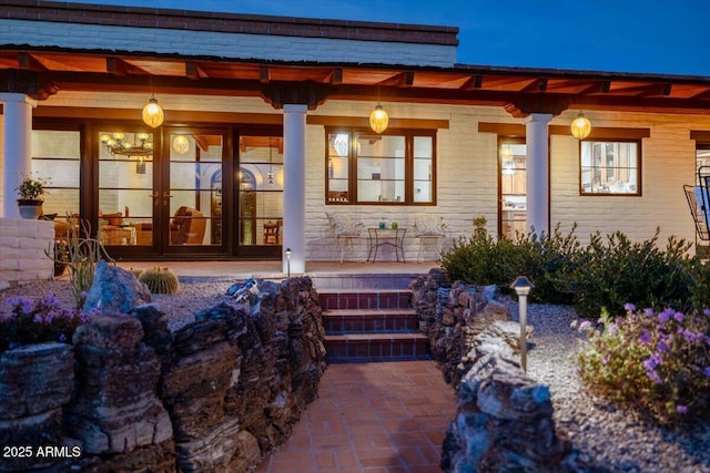 doorway to property with french doors and a porch