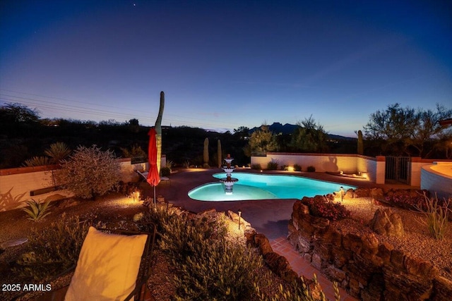 view of pool at dusk